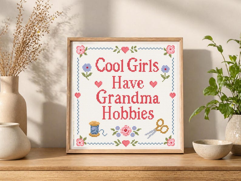 This counted cross stitch pattern combines humor, vintage charm, and classic handmade style. The quote Cool Girls Have Grandma Hobbies makes the design perfect for makers who love traditional crafts but want a playful modern message. The floral motifs, hearts, border, scissors, and thread details give it a nostalgic sampler look that feels cute, feminine, and cozy. A great PDF pattern for craft rooms, sewing rooms, and handmade gift projects.