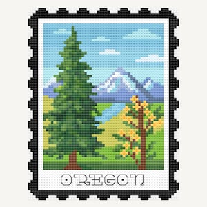 May include: Cross-stitch design of an Oregon stamp featuring a green evergreen tree, a yellow tree, and a mountain range under a blue sky. The word "OREGON" is stitched at the bottom, framed by a black border.