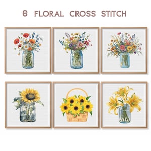 May include: Six cross stitch patterns featuring floral arrangements in mason jars and a basket of sunflowers. The patterns include a bouquet of red and yellow wildflowers, a bouquet of purple and yellow wildflowers, a bouquet of pink and yellow wildflowers, a single sunflower, a bouquet of yellow lilies, and a basket of sunflowers.