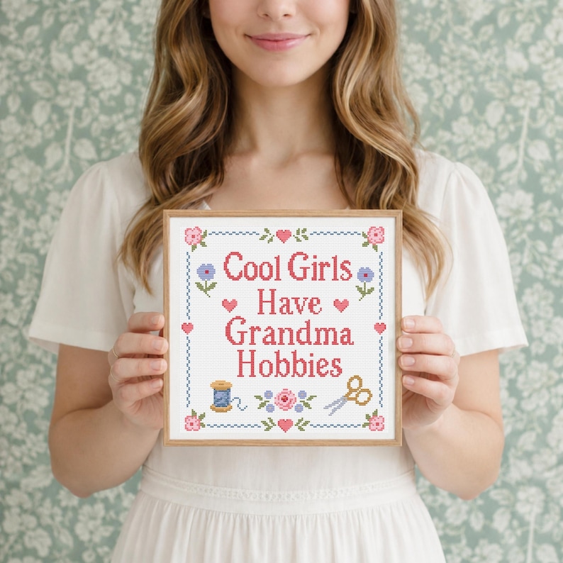 Cool Girls Have Grandma Hobbies is a modern funny quote cross stitch pattern with a traditional floral sampler style. The design includes sweet roses, small hearts, a stitched border, embroidery scissors, and thread spool details, creating a nostalgic handmade look. This PDF pattern is great for beginner and experienced stitchers who enjoy cute cross stitch projects, craft lover gifts, retro decor, and cozy feminine wall art with personality. Hot girls Have Grandma Hobbies