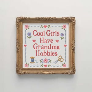 Cool Girls Have Grandma Hobbies cross stitch pattern is a fun instant download PDF for stitchers who enjoy cute quote designs and traditional sampler layouts. The pattern has a soft handmade style with floral accents, hearts, embroidery scissors, a thread spool, and a decorative stitched border. It is suitable for craft room decor, sewing room art, DIY gifts, beginner friendly stitching projects, and anyone who loves cozy hobbies with a funny modern phrase.