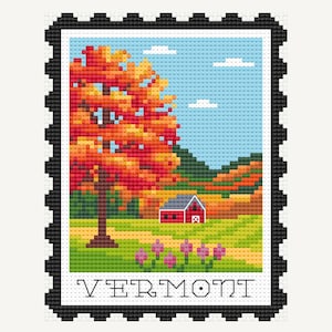 May include: Cross-stitch design of a Vermont landscape, resembling a postage stamp. Features a vibrant autumn tree, a red barn, and rolling hills under a blue sky with clouds. The word "VERMONT" is displayed at the bottom.