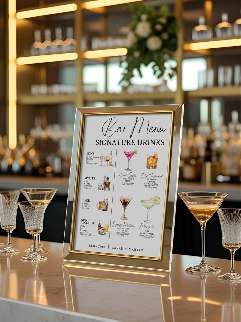 May include: A framed bar menu with gold trim displays "Bar Menu Signature Drinks." The menu lists wine, spirits, beer, and non-alcoholic options with illustrations. Several martini glasses and other glassware are on the bar.