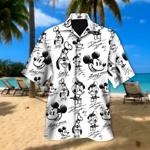 May include: White button-down shirt with black and white cartoon character illustrations of Mickey Mouse, Donald Duck, and Goofy. The shirt has a classic collar and short sleeves, ideal for a casual, beach-themed look.