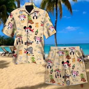 May include: A beige shirt and shorts set with a Disney pirate theme. The pattern features Mickey Mouse, Minnie Mouse, Donald Duck, and Goofy dressed as pirates, alongside pirate symbols. This set is suitable for holidays or beachwear. The shirt has short sleeves.