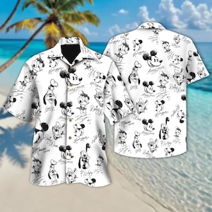 May include: White button-down shirt featuring a black and white sketch pattern of Disney characters, including Mickey Mouse, Donald Duck, and Goofy. The shirt has a classic collar and short sleeves, perfect for a casual look.