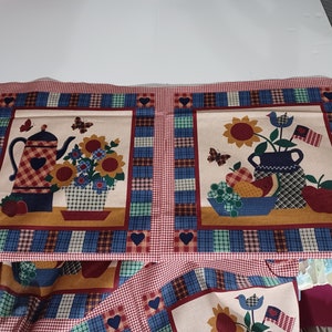 May include: Fabric panels with a country theme. Each panel features a central image of a floral arrangement, a teapot, and fruit. The borders are red and white gingham, with blue and green plaid accents. Hearts and butterflies are also included in the design.
