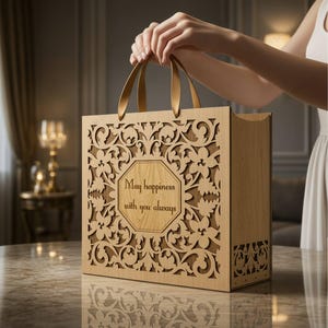 May include: A light brown wooden gift bag featuring intricate laser-cut floral patterns and a central octagonal panel with the engraved text "May happiness with you always." The bag includes two matching wooden handles and is designed for 3mm material.