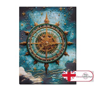 May include: A blue and gold compass with a beaded design, set against a dark blue background with white stars. The compass is surrounded by a ring of beads and has a central point with four arms.
