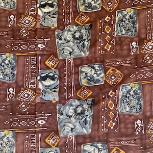 May include: A fabric with a repeating pattern of floral and geometric shapes in shades of brown, gray, and yellow. The design includes stylized flowers, diamonds, and vertical stripes, creating a vintage or bohemian aesthetic.