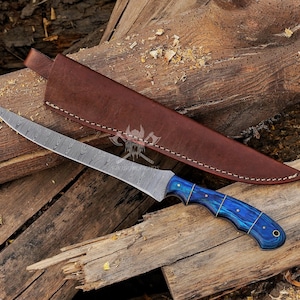 May include: A Damascus steel knife with a curved blade and a blue and gold handle, resting on a wooden surface. The knife is accompanied by a brown leather sheath. The blade has a unique pattern, and the handle has a vibrant blue hue.