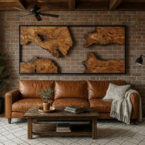 May include: A living room with a brown leather sofa, a wooden coffee table, and a large wooden artwork on a brick wall. A grey throw blanket and cushion are on the sofa. A small plant sits on the coffee table.