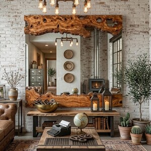 May include: A large, rustic wooden mirror with a live edge, mounted on a white brick wall. The mirror reflects a room with a fireplace, plants, and vintage decor. A wooden table and a coffee table with a typewriter and globe are in the foreground.