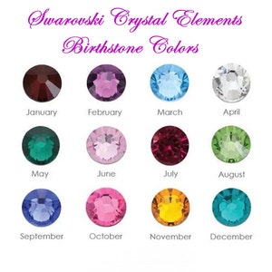 May include: A display of Swarovski Crystal Elements birthstone colours. Each month is represented by a different coloured crystal: January (dark red), February (purple), March (light blue), April (clear), May (green), June (pink), July (red), August (light green), September (dark blue), October (pink), November (yellow), and December (teal).