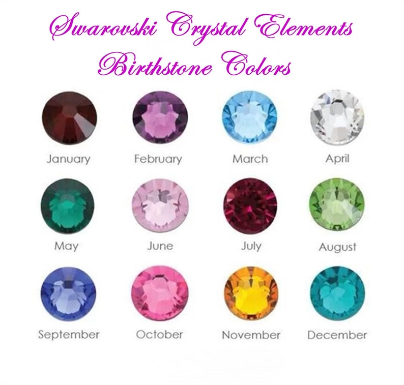 May include: A display of Swarovski Crystal Elements birthstone colours. Each month is represented by a different coloured crystal: January (dark red), February (purple), March (light blue), April (clear), May (green), June (pink), July (red), August (light green), September (dark blue), October (pink), November (yellow), and December (teal).