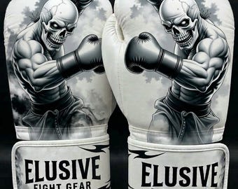 May include: A pair of white boxing gloves featuring a black and white graphic illustration of a muscular skeleton wearing boxing gloves. The wrist straps are printed with the black text ELUSIVE FIGHT GEAR and decorative black tribal-style accents.