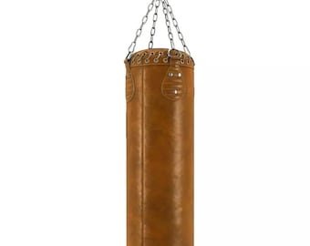May include: A brown leather punching bag suspended from a silver chain. The cylindrical bag features a stitched top and riveted details. The bag is designed for boxing and martial arts training.