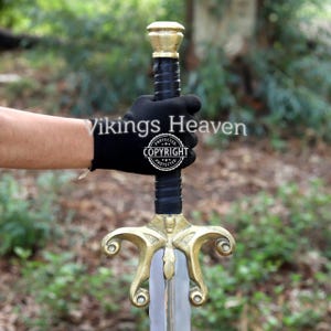 Fully handmade He-Man Power Sword replica with a carbon steel blade, solid brass guard and pommel, inspired by the Masters of the Universe movie. High-quality fantasy sword perfect for cosplay, display, or as a collectible gift for fans of classic 80s heroes.