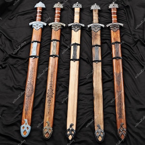 May include: Five wooden swords with ornate silver and black metal detailing. The sheaths are engraved with intricate patterns. The hilts are wrapped in brown leather. The swords are displayed on a black background.