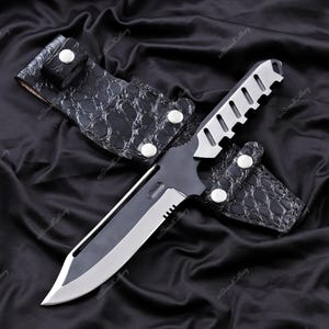 May include: A tactical knife with a silver blade and a black handle, in a black leather sheath. The sheath has a crocodile skin texture and is secured with silver press studs. The knife's handle has a silver top.