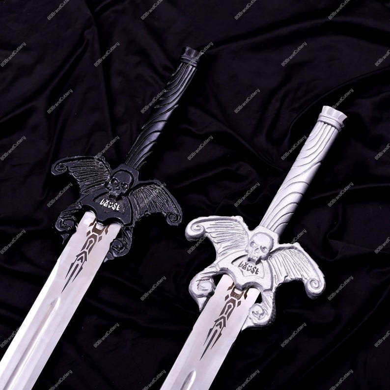 May include: Two decorative swords with silver blades. One sword is black, the other is silver. Both have skull and wing designs on the hilt. The word "LAUST" is visible on the blade guard. The background is a dark, textured fabric.