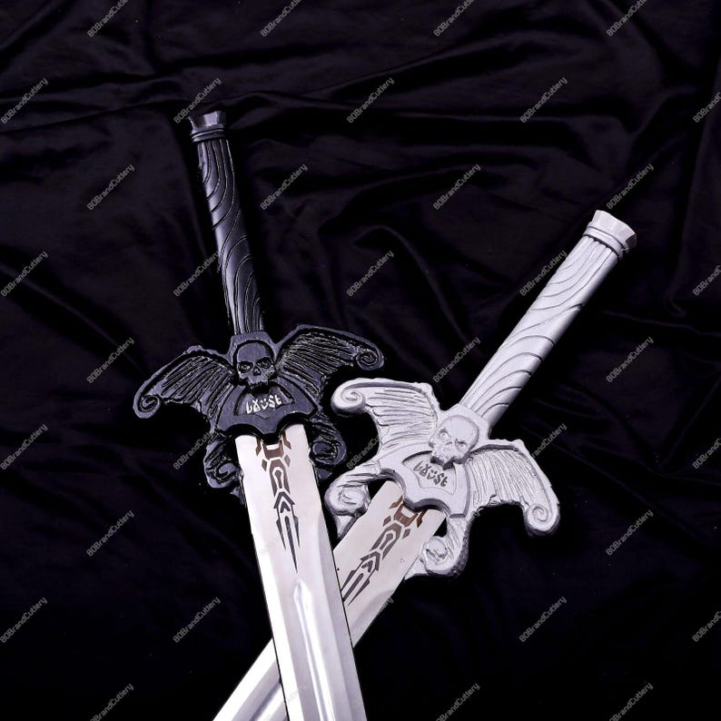 May include: Two decorative swords with silver blades and ornate handles. One sword is black, the other is silver. Both feature a skull and wing design on the crossguard and the word "CAUSE". The swords are displayed against a black background.