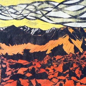 May include: An abstract landscape print featuring a mountain range with snow-capped peaks. The artwork uses a palette of orange, black, and yellow, with a textured appearance. The sky has a unique pattern of black and white lines.