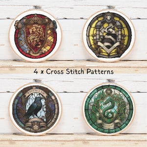 May include: Four cross-stitch patterns in wooden hoops, each depicting a house crest. The crests are a lion, badger, raven, and serpent, set against stained-glass style backgrounds. The text "4 x Cross Stitch Patterns" is also visible.