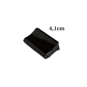 May include: Black plastic corner guard with a 4.1 cm measurement.