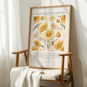 Könnte beinhalten: Ein gerahmter Druck mit einem floralen Design aus gelben Sonnenblumen und weißen Gänseblümchen. Der Druck enthält den Text "THE LORD IS MY SHEPHERD" und einen Bibelvers. Der Rahmen ist hellbraun.
