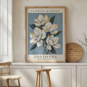Louisiana Flower Market poster featuring the state flower Magnolia, elegant white blossoms with golden highlights and deep green leaves against a soft blue textured background in vintage botanical art style.