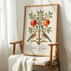 May include: A framed art print with a watercolour illustration of a tree bearing red pomegranates and green leaves. Two birds are perched on a branch. The text reads: "THE FRUIT OF THE RIGHTEOUS IS A TREE OF LIFE PROVERBS 11:30."