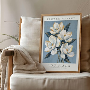 Louisiana Flower Market poster featuring the state flower Magnolia, elegant white blossoms with golden highlights and deep green leaves against a soft blue textured background in vintage botanical art style.