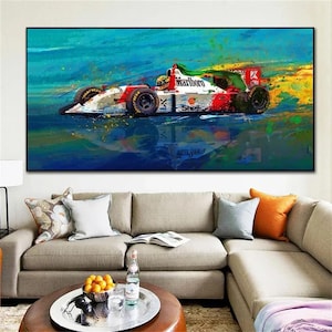 May include: A vibrant painting of a Formula 1 race car in motion. The car is white, red, and black, with sponsor logos including "Marlboro" and "Shell." The background features dynamic brushstrokes of blue, yellow, and green, creating a sense of speed and energy.