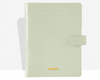 May include: A light green, faux crocodile-textured planner with a gold-colored rectangular accent that reads "COCO LONDON". The planner has a matching tab closure on the right side.