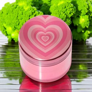 Pink heart-themed 4-piece herb grinder with pollen catcher and scraper, perfect cute grinder for women, stylish gift for her.