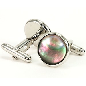 May include: A pair of silver cufflinks with a round, iridescent abalone shell inlay.