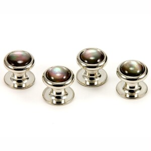 May include: Set of four silver cufflinks with black and iridescent mother of pearl insets.