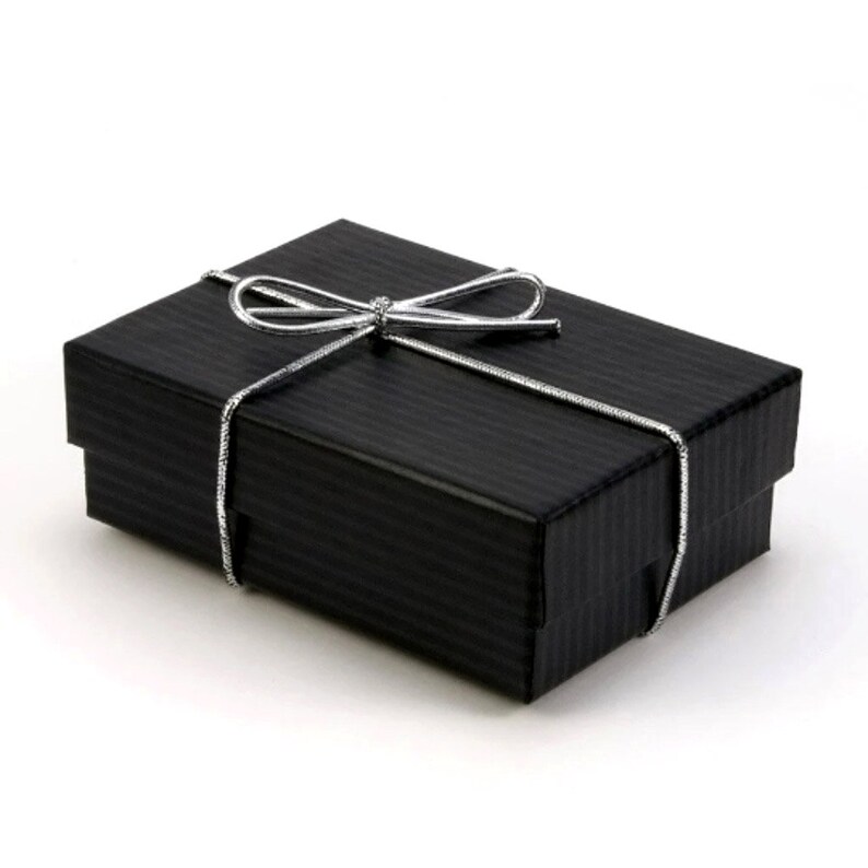 May include: A black gift box with a silver ribbon tied in a bow.