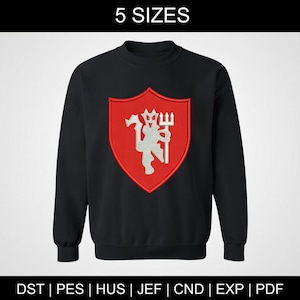 May include: Black sweatshirt with a red shield emblem featuring a white devil figure holding a trident. The text "5 SIZES" is at the top. The bottom of the image displays file format abbreviations: DST, PES, HUS, JEF, CND, EXP, and PDF.