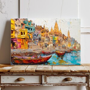 May include: A colorful painting of a cityscape with buildings and temples along a river. The buildings are painted in shades of yellow, orange, and red, and the river is a vibrant blue. There are several boats on the river, and the sky is a light blue.