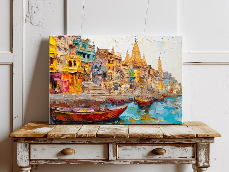 May include: A colorful painting of a cityscape with buildings and temples along a river. The buildings are painted in shades of yellow, orange, and red, and the river is a vibrant blue. There are several boats on the river, and the sky is a light blue.