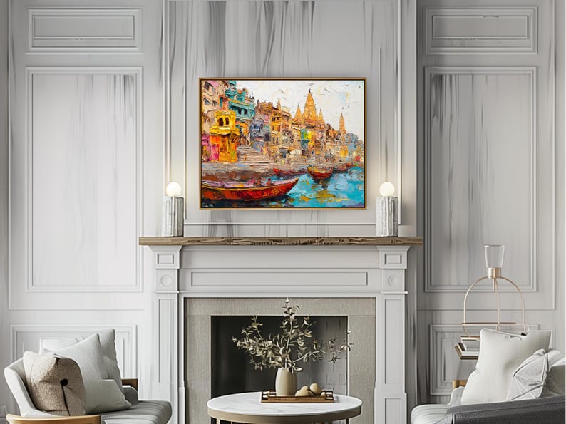 May include: A colorful painting of a cityscape with buildings and boats on a river. The painting is framed in gold and hangs above a fireplace.