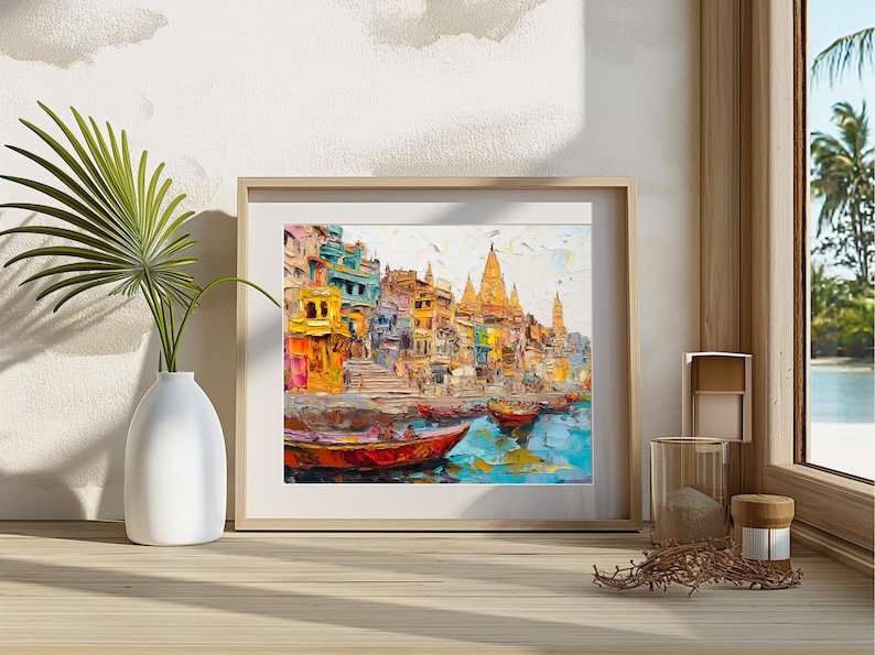 May include: A colorful painting of a cityscape with buildings and boats on a river. The buildings are painted in shades of yellow, orange, blue, and green. The boats are painted in shades of red, blue, and green. The painting is framed in a wooden frame.