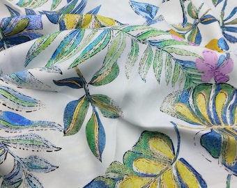 May include: A white fabric featuring a repeating botanical print of tropical leaves and small flowers. The design incorporates shades of green, blue, and yellow with light purple accents, rendered in a sketched style with visible black outlines.