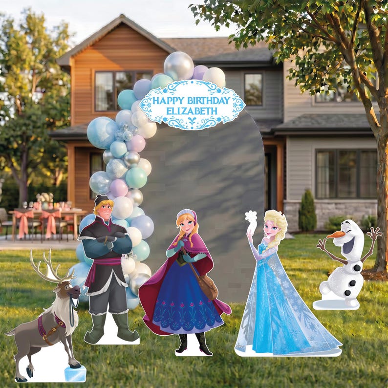 May include: A Frozen-themed party display featuring a large gray arched backdrop with a blue Happy Birthday Elizabeth sign, a balloon garland in blue, white, and silver, and cardboard cutouts of Sven, Kristoff, Anna, Elsa, and Olaf.