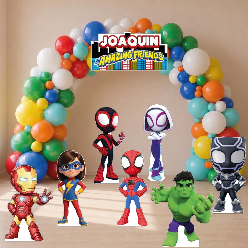 May include: A colorful balloon arch featuring a sign that reads JOAQUIN AND HIS AMAZING FRIENDS. Standing in front are cardboard cutouts of Iron Man, Ms. Marvel, Miles Morales, Spider-Man, Ghost-Spider, Hulk, and Black Panther in a group display.
