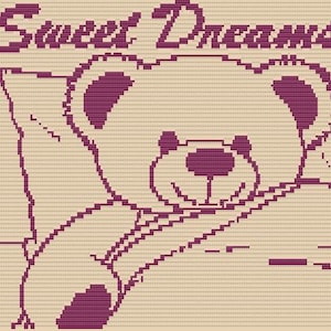 May include: A cross-stitch design featuring a smiling teddy bear in shades of purple on a beige background. The words "Sweet Dreams" are stitched above the bear. The bear is lying on a pillow.