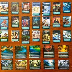 May include: A collection of 48 trading cards featuring various aquatic creatures, landscapes, and mythical beings. The cards are arranged in rows on a wooden surface. The cards have a blue and white color scheme with illustrations of seahorses, mermaids, and other fantasy creatures.