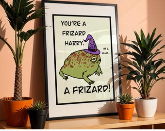 May include: Framed art print featuring a cartoon frog wearing a wizard hat. The frog is green with brown spots and a purple hat with stars. Text on the print reads "You're a Frizard Harry. A Frizard!"